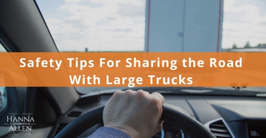 Car driving behind large truck